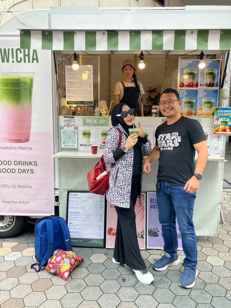 Tourist giving thumbs up with matcha latte at WOW!CHA Asakusa Tokyo