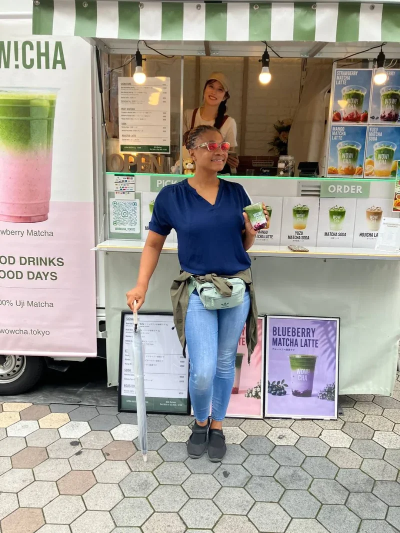 Customer holding matcha latte at WOW!CHA kitchen car, Asakusa Tokyo