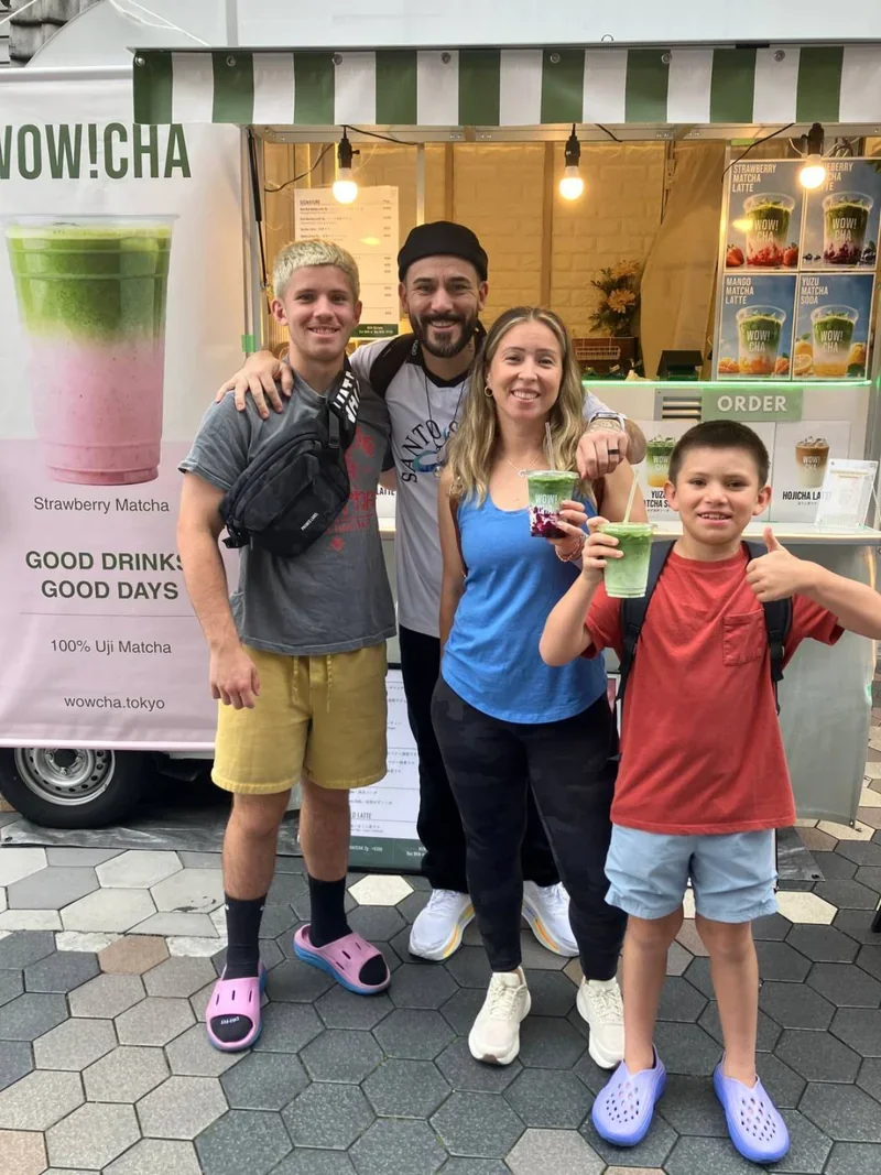 Tourist family enjoying matcha drinks at WOW!CHA kitchen car in Asakusa, Tokyo
