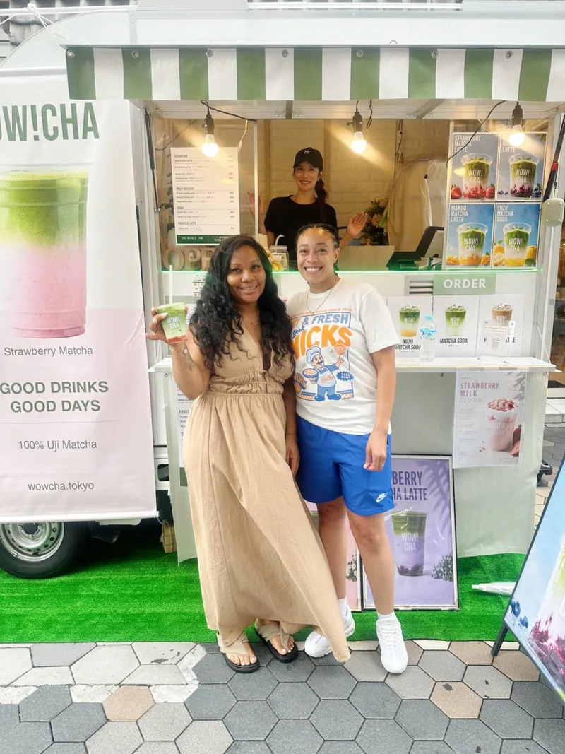 Two friends holding Strawberry Matcha Latte at WOW!CHA kitchen car, Asakusa Tokyo