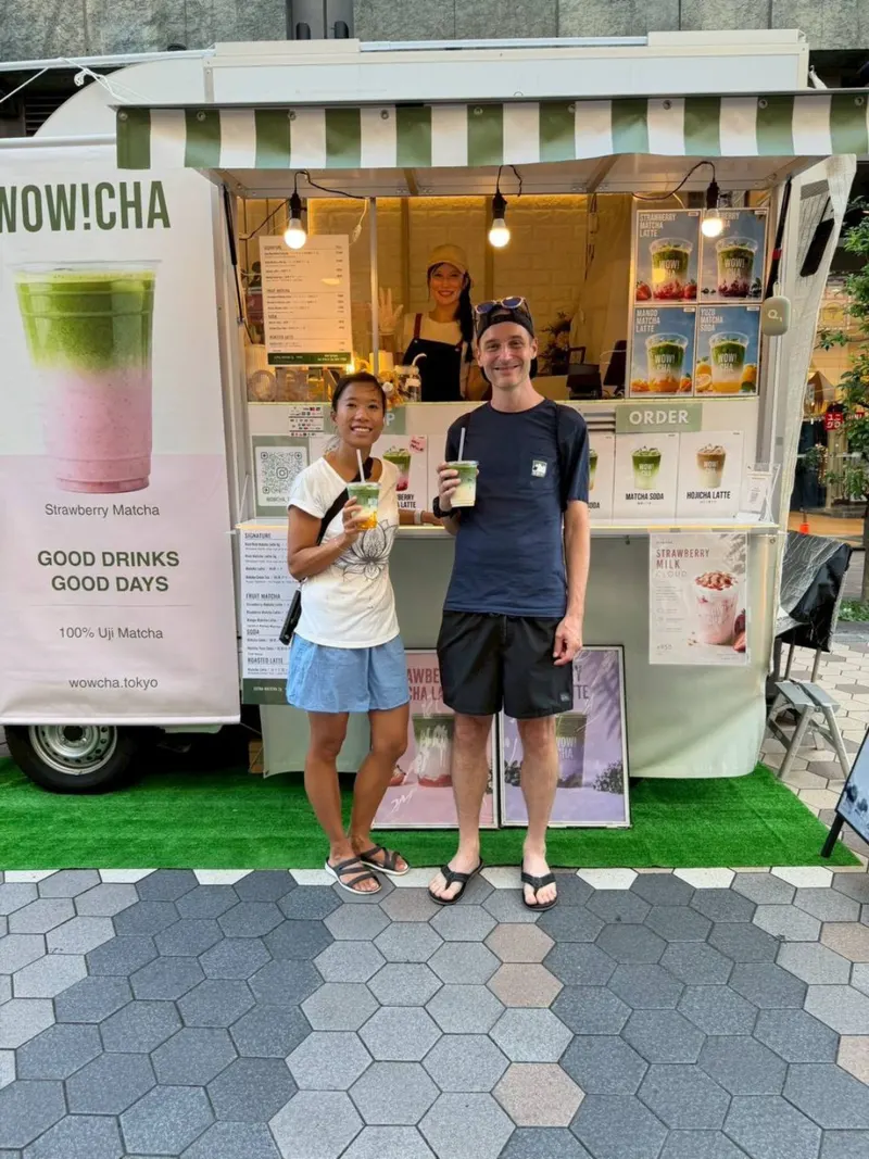 Couple holding matcha drinks at WOW!CHA kitchen car, Asakusa Tokyo