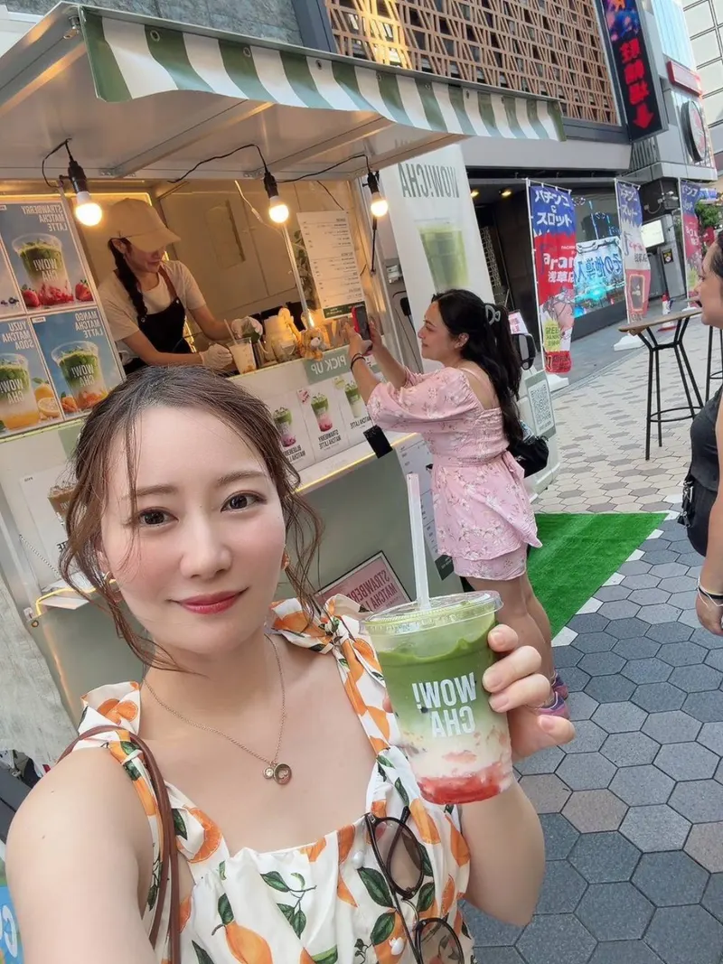 Tourist taking a selfie with Strawberry Matcha Latte at WOW!CHA kitchen car, Asakusa Tokyo