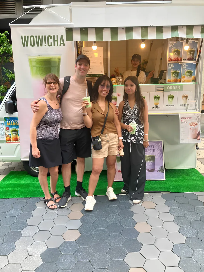 Family of four holding matcha drinks at WOW!CHA kitchen car, Asakusa Tokyo